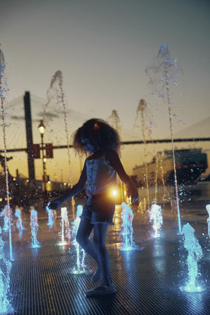 Children playing in fountain at MLK Park on the river with Talmadge Bridge