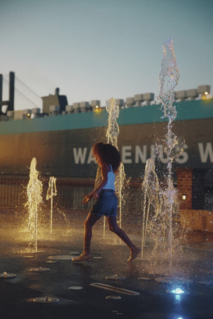 Children playing in fountain at MLK Park on the river with Talmadge Bridge