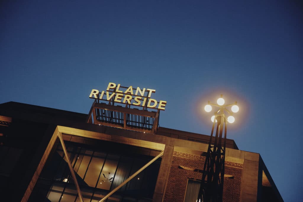 Plant Riverside sign lit up at night in Savannah exterior of the building