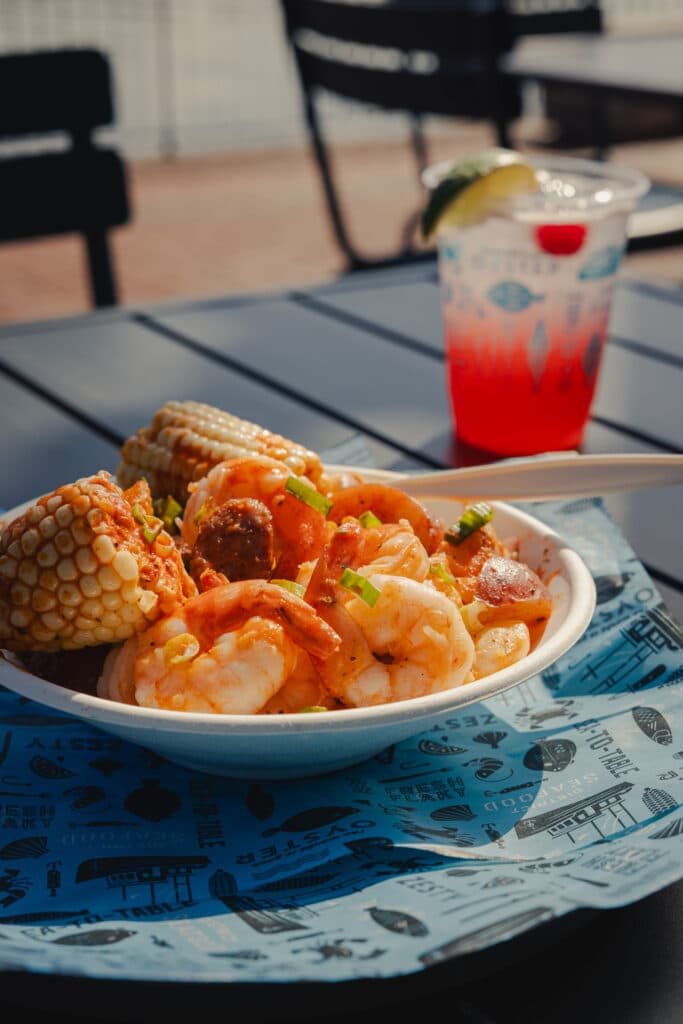 District Seafood shrimp, corn, and drinks at Plant Riverside District Savannah